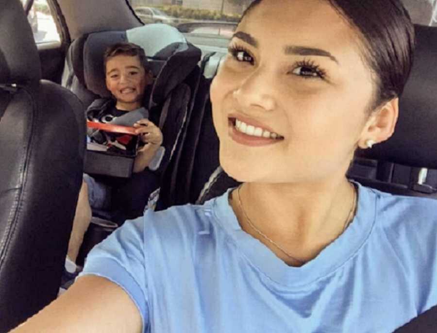 Woman in denim button down smiling in driver