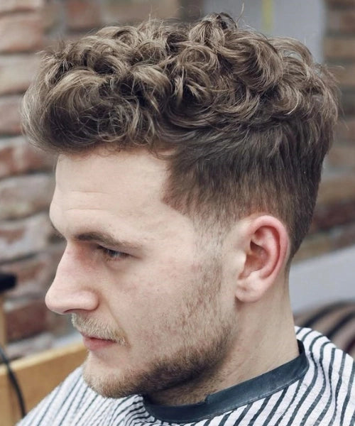 Curly quiff haircut with voluminous natural curls on top and sharp faded sides.