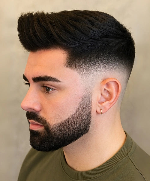 Quiff mid fade hairstyle with bold textured volume on top and seamless faded sides.
