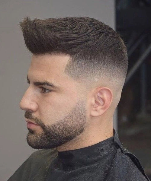Pompadour quiff haircut with tall lifted top and sleek faded sides.