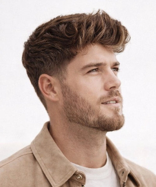 Medium length quiff with neatly blended sides and a lifted front, showing full volume and smooth natural movement