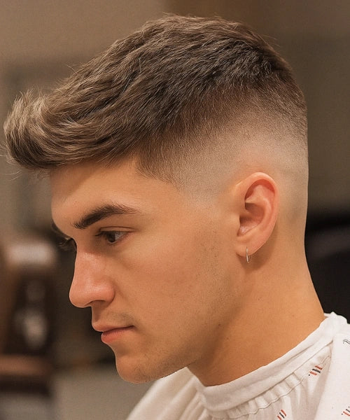 Skin fade quiff haircut with lifted voluminous top and seamless skin fade.
