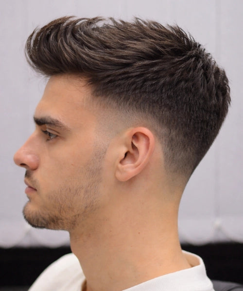 Mid taper quiff with softly tapered sides and a thicker top, creating a simple lifted front with clean balance