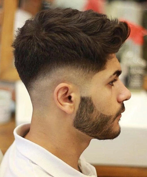 Drop fade quiff with a fade curving behind the ears and a longer top that lifts forward and flows back
