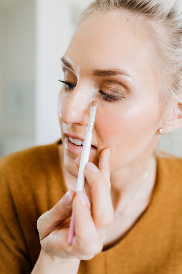 NAKED Palette Tutorial featured by top US beauty blog A Slice of Style; Image of woman in mustard sweater, applying eye shadow.