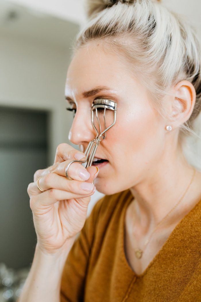 NAKED Palette Tutorial featured by top US beauty blog A Slice of Style; Image of woman in mustard sweater, applying eye shadow.