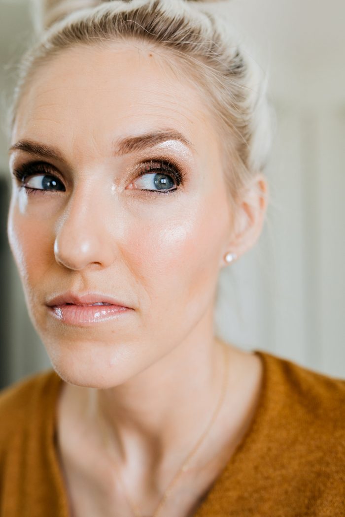 NAKED Palette Tutorial featured by top US beauty blog A Slice of Style; Image of woman in mustard sweater, applying eye shadow.