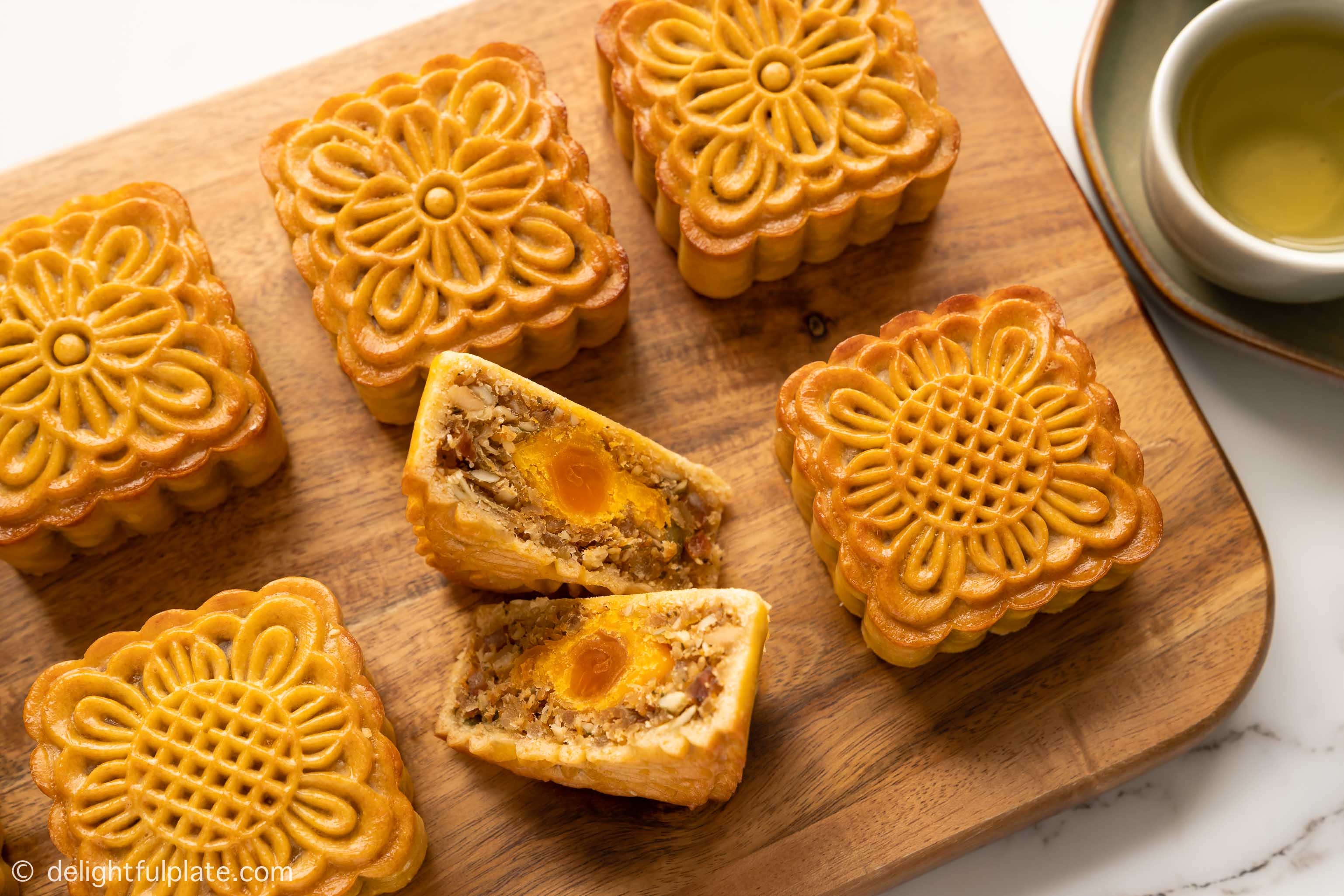 a cut slice of Vietnamese mooncakes with mixed nuts